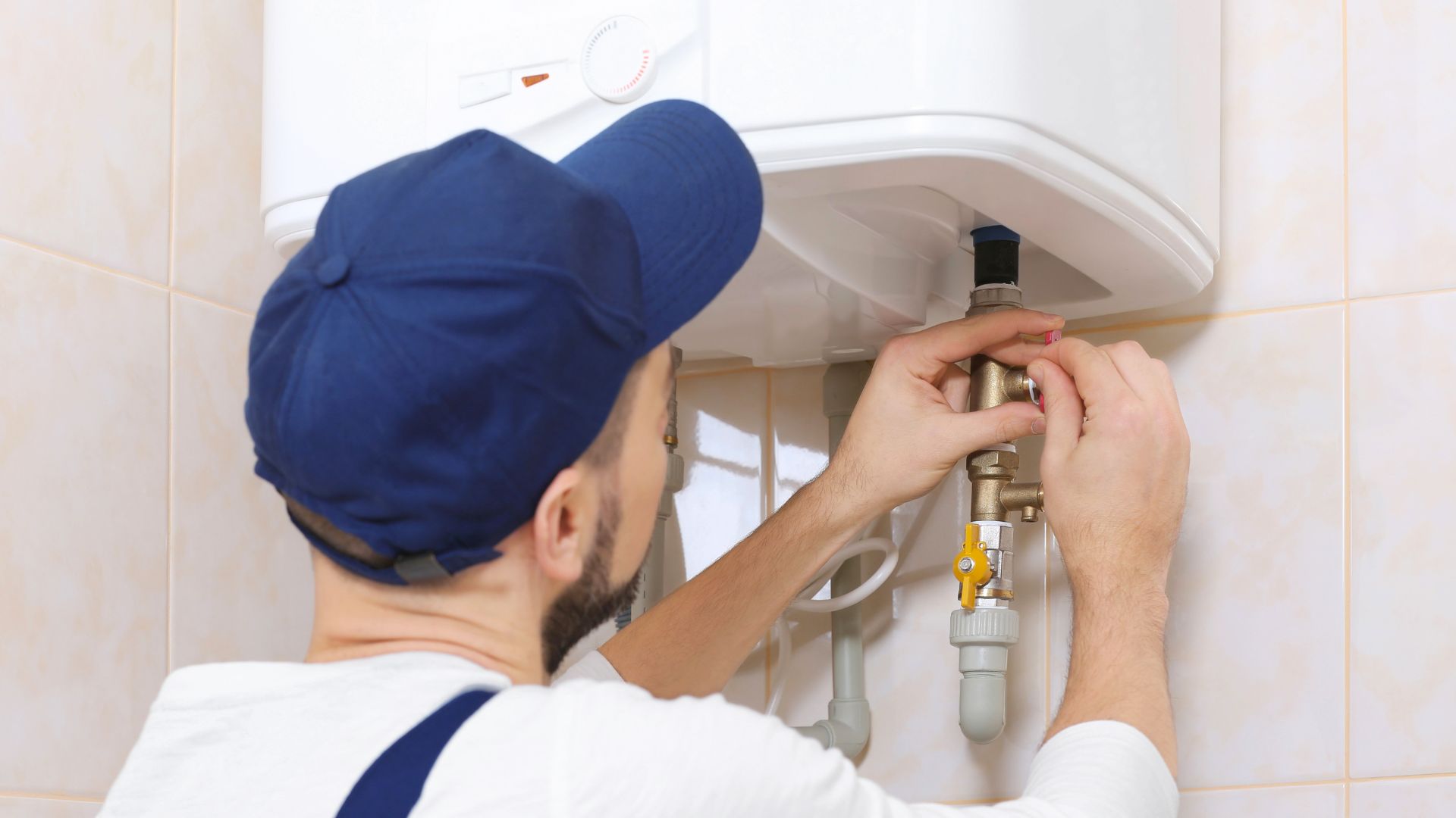 A man installing a tankless water heater